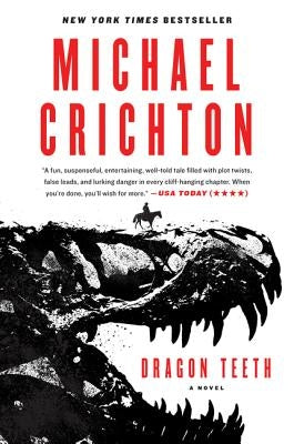 Paperback copy of Dragon Teeth by Harper Paperbacks, showing the book's cover with dark and fiery artwork.