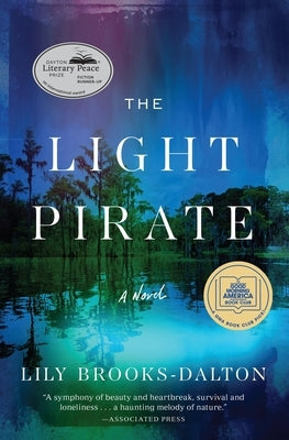 Paperback copy of The Light Pirate by Grand Central Publishing, with cover featuring ocean and light-themed artwork.