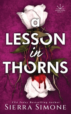 Paperback copy of "A Lesson in Thorns" by Bloom Books, featuring the book's cover with dark, thorny imagery.