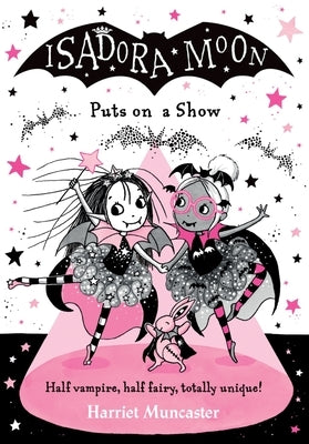 Paperback copy of Isadora Moon Puts on a Show by Oxford Children's, featuring colorful cover art and illustrations.