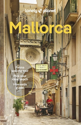 Paperback Lonely Planet Mallorca travel guide featuring colorful cover with scenic images of Mallorca's beaches and landmarks.