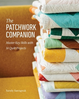 Paperback copy of "The Patchwork Companion" by Stash Books, showing a colorful quilt pattern on the cover.