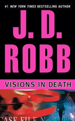 Mass market paperback of "Visions in Death" by Berkley Books, showing the book cover with dark and mysterious imagery.