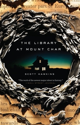 Paperback copy of "The Library at Mount Char" by Crown Publishing Group, featuring a dark and mysterious book cover.