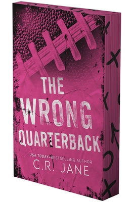 Paperback copy of "The Wrong Quarterback: A Football Romance" by Podium Publishing, featuring a cover with football imagery.