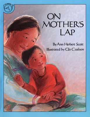 Paperback copy of "On Mother's Lap" by Clarion Books, showing colorful illustrations on the cover.