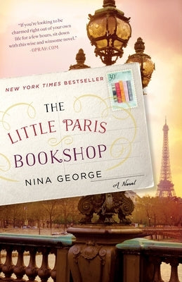 Paperback of The Little Paris Bookshop by Ballantine Books, showing the book cover with a Paris-themed design.