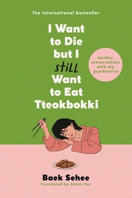 Paperback book titled "I Want to Die But I Still Want to Eat Tteokbokki" by Bloomsbury Publishing, featuring a colorful cover design.