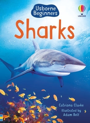 Open paperback book about sharks from Usborne Books showing colorful underwater illustrations of various shark species.
