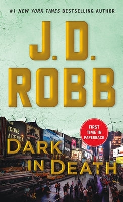 Mass market paperback of Dark in Death by St. Martin's Press, featuring a dark-themed cover with a cityscape background.