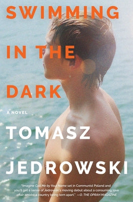Paperback of "Swimming in the Dark" by William Morrow & Company, featuring a dark, moody cover design.