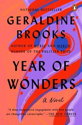 Paperback copy of "Year of Wonders" by Penguin Books, featuring a cover with historical imagery and book title text.