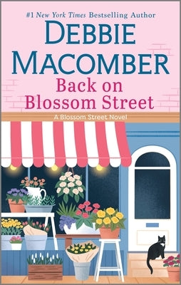 Mass market paperback of "Back on Blossom Street" by Mira Books, showing the book cover with floral artwork and title.