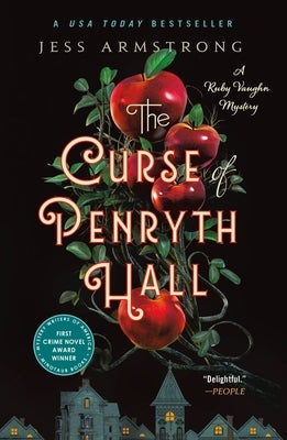 Paperback copy of The Curse of Penryth Hall mystery novel by Minotaur Books, showing the book cover with dark, atmospheric artwork.