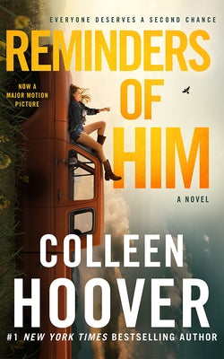 Paperback copy of "Reminders of Him" novel by Montlake, showing the book cover with title and author details.