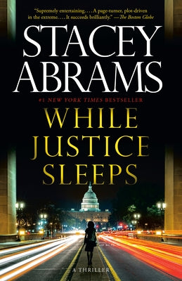 Paperback of "While Justice Sleeps" thriller novel by Anchor Books, showing the book cover with title and author text.