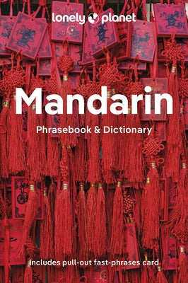 Paperback Lonely Planet Mandarin Phrasebook and Dictionary with colorful cover and sample pages open showing Chinese language content.