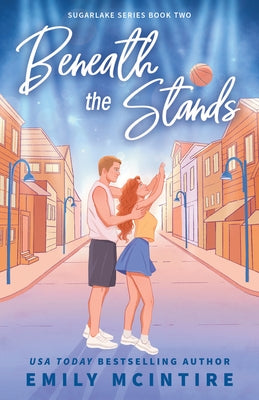 Paperback copy of Beneath the Stands by Bloom Books with a colorful cover art featuring sports and cheering fans.