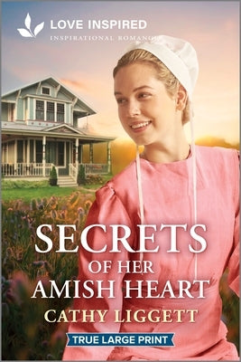 Paperback of "Secrets of Her Amish Heart" inspirational romance by Love Inspired True Large Print, featuring a serene Amish scene.