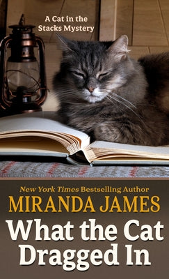 Large print paperback of "What the Cat Dragged in" by Wheeler Publishing, showing the book cover with title and author.