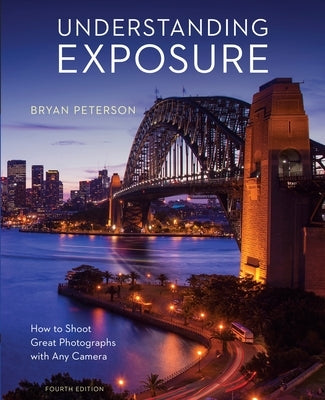 Paperback copy of "Understanding Exposure, Fourth Edition" by Amphoto Books, featuring cover art on a plain background.