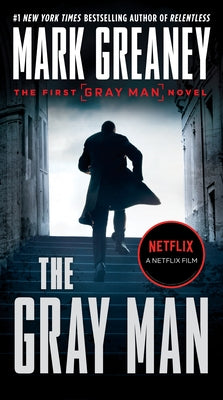 Mass market paperback of "The Gray Man" by Berkley Books, featuring the book's cover with title and author information.