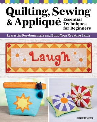 Paperback book titled "Quilting, Sewing & Applique: Essential Techniques for Beginners" by Landauer, showing a colorful fabric and sewing supplies.