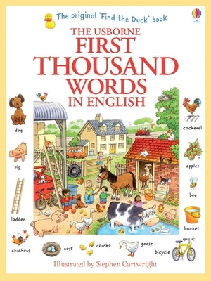 Open Usborne First Thousand Words in English paperback book showing colorful illustrated pages for language learning.