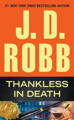 Mass market paperback of "Thankless in Death" by Berkley Books featuring the book cover with dark tones and title text.