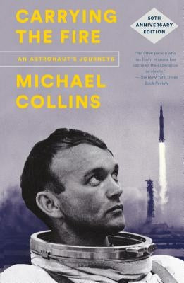 Paperback copy of "Carrying the Fire: An Astronaut's Journeys" by Farrar, Straus and Giroux, featuring the book cover with astronaut imagery.