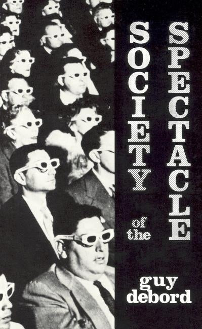 Black & Red paperback of Society of the Spectacle featuring a cover with bold, abstract artwork and title text.