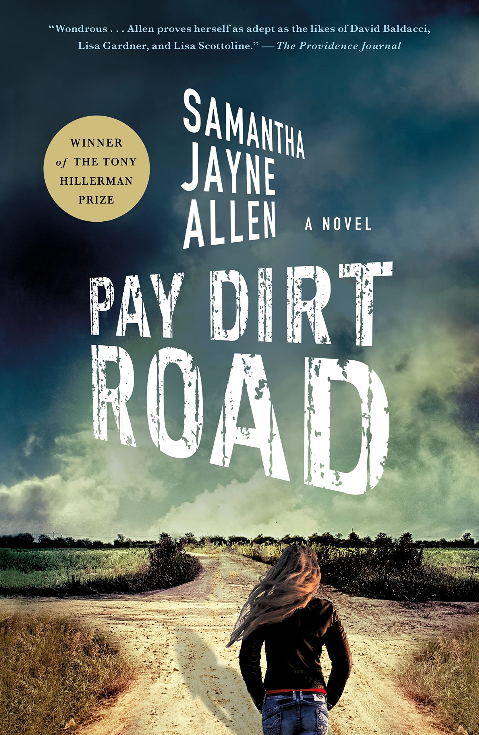Paperback book titled "Pay Dirt Road" by Minotaur, featuring a cover with a rugged dirt road scene.