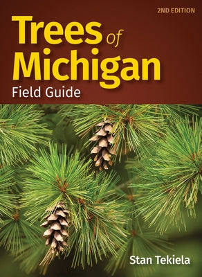 Paperback Trees of Michigan Field Guide by Adventure Publications, showing illustrated pages of various Michigan trees.