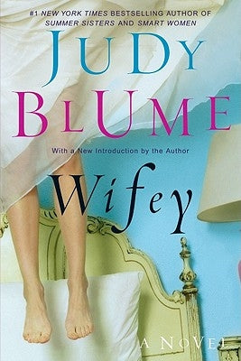 Close-up of a book titled "Wifey" by Berkley Books, showing its colorful cover design and title prominently displayed.