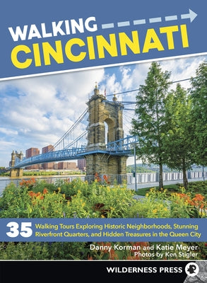 Paperback book titled "Walking Cincinnati" by Wilderness Press, featuring a cover with images of Cincinnati's historic neighborhoods and riverfront.