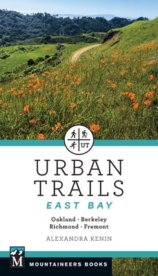 Paperback guidebook titled Urban Trails East Bay by Mountaineers Books, featuring a map and trail images of Oakland, Berkeley, Fremont, and Richmond.