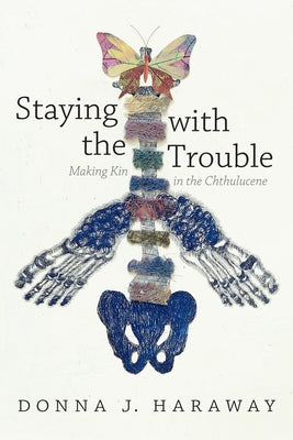 Paperback copy of "Staying with the Trouble: Making Kin in the Chthulucene" by Duke University Press, featuring the book cover.