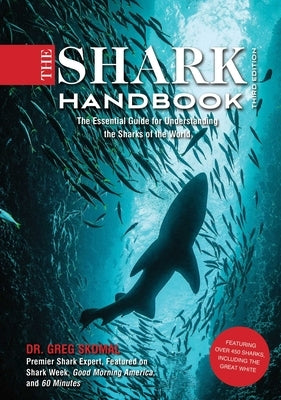 Paperback of The Shark Handbook Third Edition by Cider Mill Press, featuring illustrations and information on great white sharks and ocean biology.