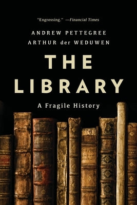 Paperback copy of "The Library: A Fragile History" by Basic Books, featuring a close-up of the book cover with a vintage library background.