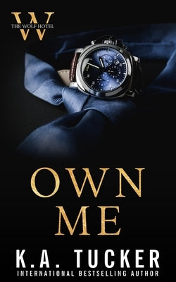 Paperback of "Own Me" by K.A. Tucker Books Ltd., featuring a cover with dark and moody artwork.