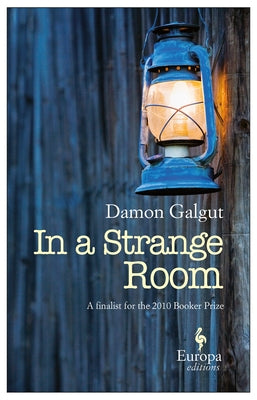 Paperback of "In a Strange Room" by Europa Editions, featuring the book cover with abstract artwork and title text.