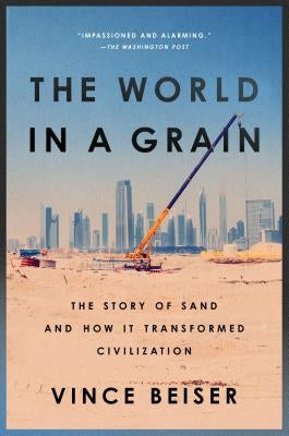 Paperback of "The World in a Grain" book by Riverhead Books showing the cover with sand and desert imagery.