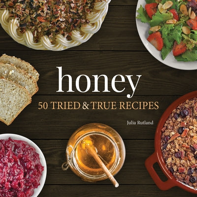 Open honey recipe book titled "Honey: 50 Tried & True Recipes" by Adventure Publications with colorful pages and recipe illustrations.