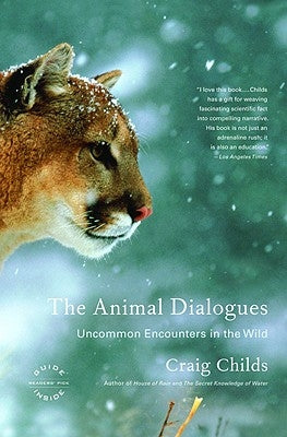 Paperback copy of "The Animal Dialogues: Uncommon Encounters in the Wild" by Back Bay Books, featuring wildlife photography on the cover.