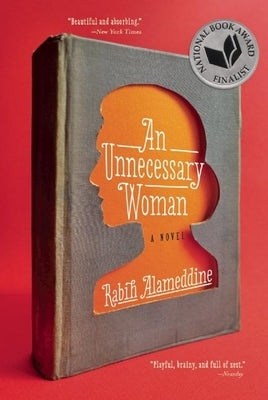 Paperback of An Unnecessary Woman by Grove Press featuring a close-up of the book cover with text and design elements.