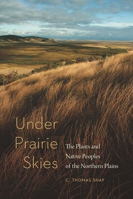 Paperback book titled "Under Prairie Skies" by Bison Books, featuring cover art with plants and native peoples of the Northern Plains.