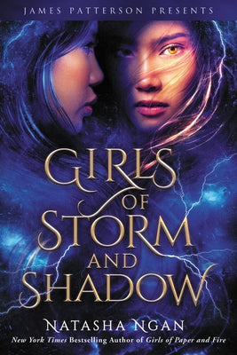 Paperback copy of Girls of Storm and Shadow by Jimmy Patterson featuring the book cover with dark, stormy illustrations.