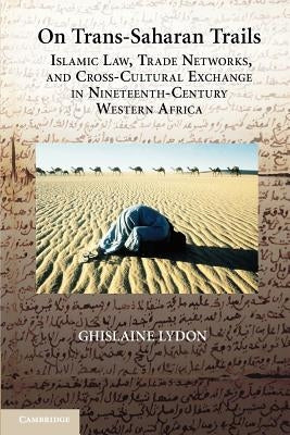 Paperback book titled "On Trans-Saharan Trails" by Cambridge University Press, featuring a cover with historical maps and desert scenes.