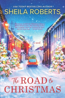 Paperback copy of "The Road to Christmas" holiday romance novel by Mira Books, featuring festive-themed cover art.