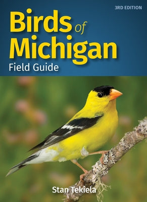 Paperback Birds of Michigan Field Guide by Adventure Publications showing colorful bird illustrations and detailed species descriptions.